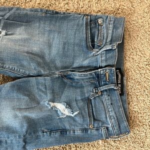 Express high rise skinny jeans with fringe bottoms